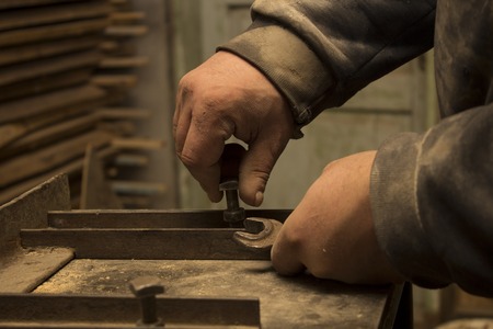 Master's hands are adjust the equipment with wrenchの写真素材