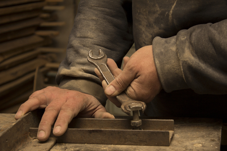 Master's hands are adjust the equipment with wrenchの写真素材