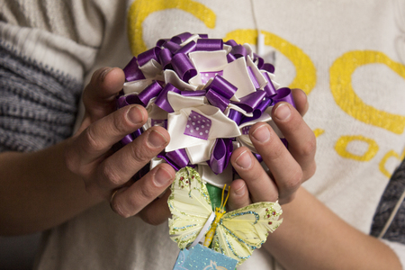 Woman  creates a bouquet with ping ribbonの写真素材