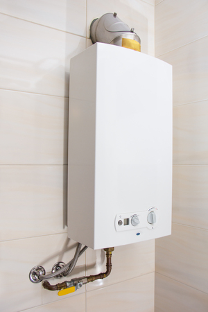 Home gas water heater - boiler in bathroom for hot waterの写真素材