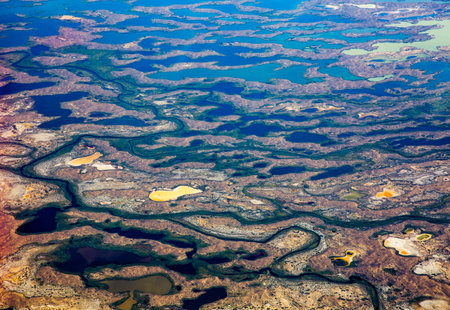 Aerial view of a small river in the middle of a desert