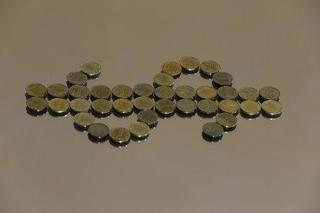 Coins in the shape of a car on a gray background.