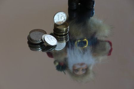Russian ruble coins with a doll reflection on the mirror surface.