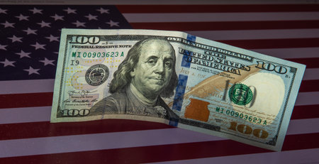 American dollars on a background of the flag of the United States of America