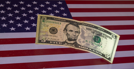 American dollar banknote on the background of the flag of the United Statesの写真素材
