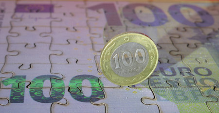 Euro coin on a jigsaw puzzle with the word 100 euro.