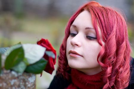 Closeup of redhead girl with a roseの写真素材