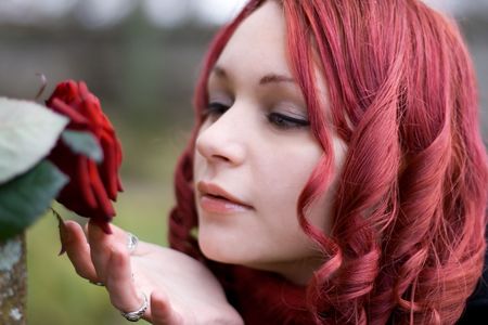 Closeup of redhead girl with a roseの写真素材