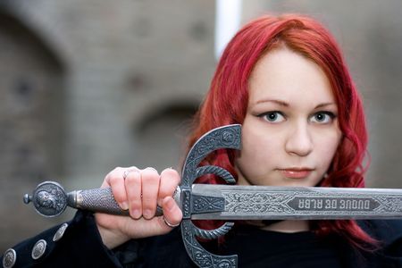Redhead gothic girl with a ancient swordの写真素材