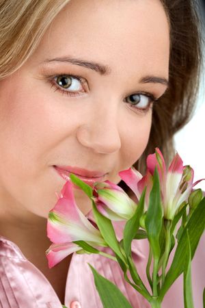 Portrait of young attractive girl with fresh flowersの写真素材