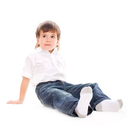 Young adorable boy sitting on isolated whiteの写真素材
