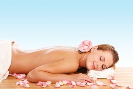 Young attractive woman lying and relaxing in spa centerの写真素材