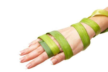 Hand wrapped in leaf over isolated whiteの写真素材