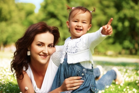 Young mother with child outside on a summer day.の写真素材