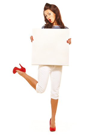 Retro styled girl holding blank white frameの写真素材