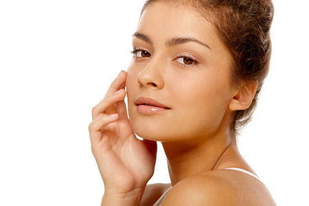 Closeup portrait of young olive skin girl over isolated white backgroundの写真素材