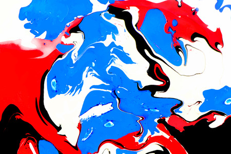 Abstract ink background. Marble style. Red black blue ink in water