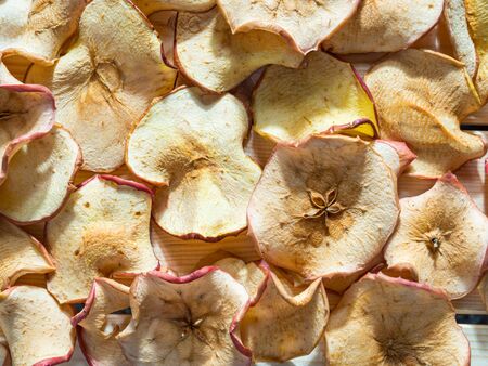 Top view of apple chips background illuminated by sunlightの写真素材