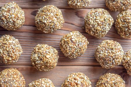 Low-fat energy balls with nuts on wooden background.の写真素材