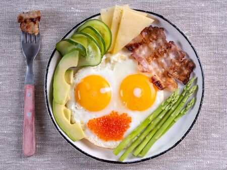 ketogenic diet breakfast on the white plate on linen fabric.の写真素材