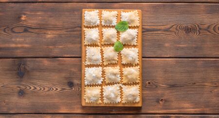 op View of Fresh Homemade Ravioli on Wooden Background. With copy space.の写真素材