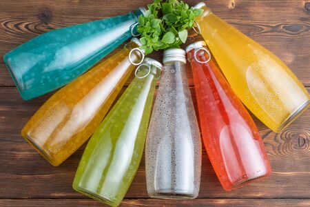 Five bottles of Basil Seed with basil leaves on a wooden background.の写真素材