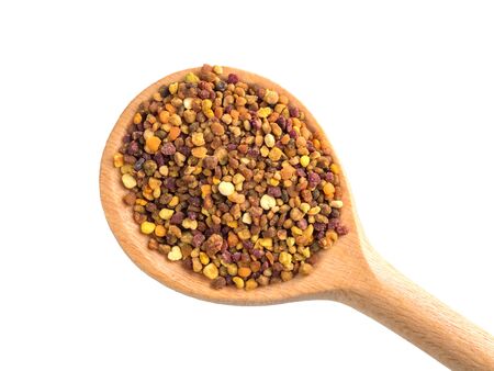 Top view of the wooden spoon of bee pollen isolated on whiteの写真素材