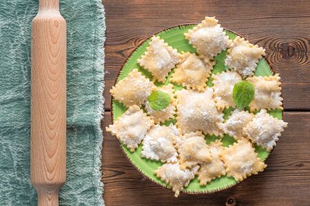 Top View of Fresh Homemade Ravioli on Wooden Background With Rolling Pinの写真素材