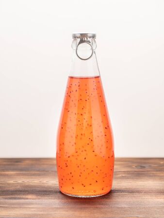 A bottle of Basil Seed Drink on a white background. Soft focus. Red colorの写真素材