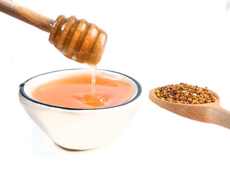 Bowl with bee pollen isolated on white. Nutritional supplementの写真素材