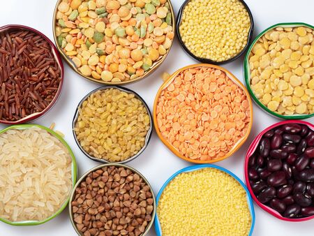 Top view of cereals and grains in bowls on white backgroundの写真素材