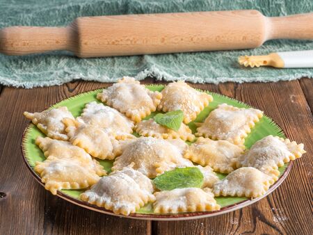 Perspective View of Fresh Homemade Ravioli on Wooden Backgroundの写真素材