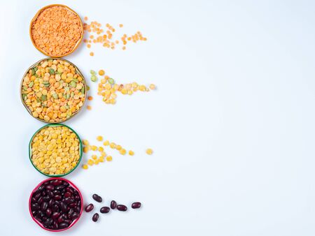 Top view of cereals and grains in bowls on white backgroundの写真素材