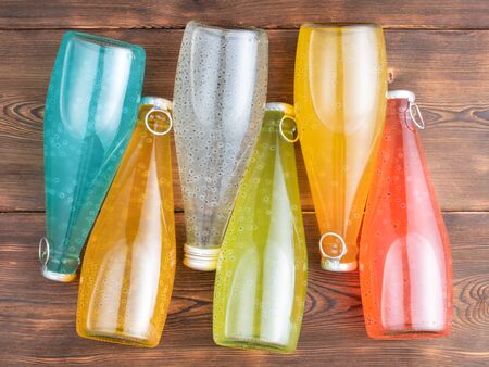 Six bottles of Basil Seed with basil leaves on a wooden background.の写真素材