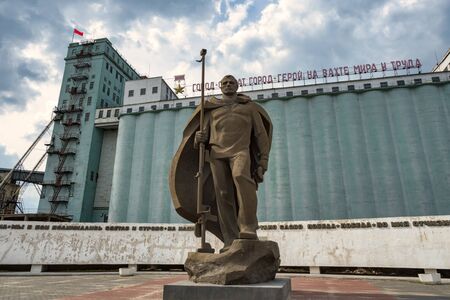 Volgograd, Russia - May, 6, 2019. The Monument the Resident of Severomorsk with the Anti-tank Gun in front of the Grain Elevator.のeditorial素材