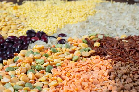 Close up view of different types of grains and cereals on a wooden background. Selective focusの写真素材