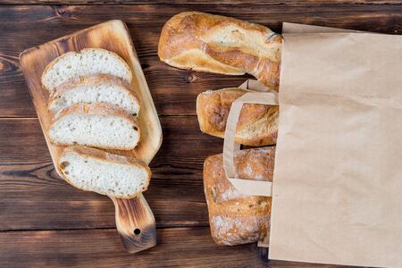 View of Bread in a Reusable zero waste textile bag on the wooden background.の写真素材