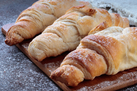 Close-up view of Homemade croissants on a brown deskの写真素材
