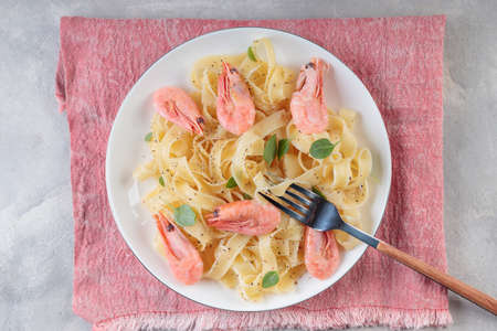 Pasta fettuccine with shrimp in ceramic plate.の写真素材
