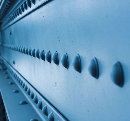 Blue toned bolts on surface.の写真素材