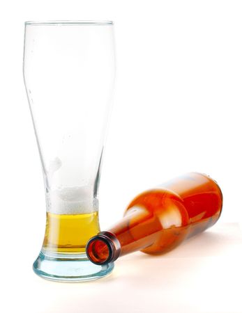 Glass with beer and empty bottleの写真素材