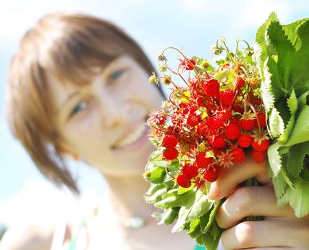 Young smiling woman with srawberry bouquetの写真素材