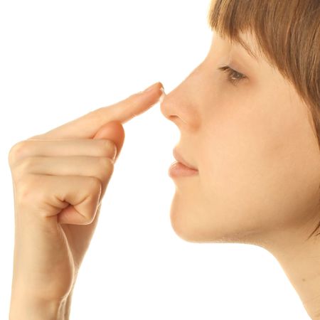 Young woman with cream on noseの写真素材