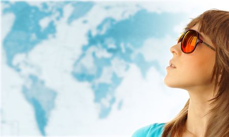 Young woman in red glasses near world mapの写真素材