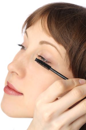 Young woman doing make-upの写真素材