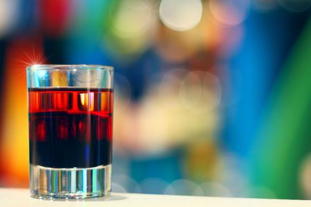 Glass with coctail standing on table edge in nightclubの写真素材