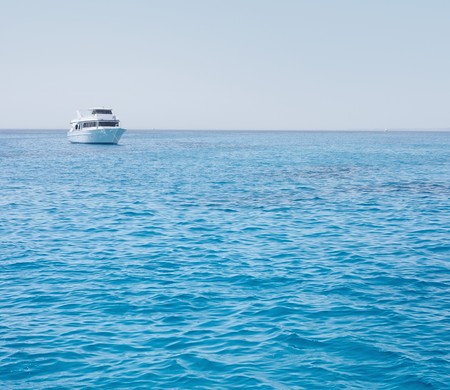 Alone speed boat in clear blue seaの写真素材