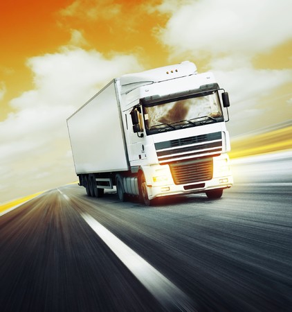 White truck on asphalt road under red abstract sky with cloudsの写真素材