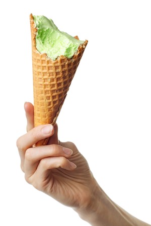 Bitten icecream cone in handの写真素材
