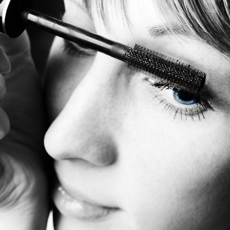Young woman with make up brushの写真素材